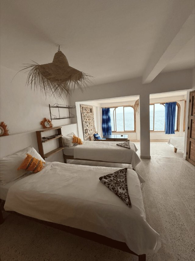 Beachfront apartment bedroom with sea-view windows