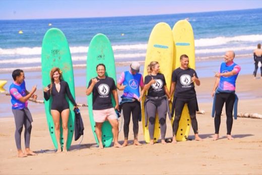 Surf students with boards on the beach