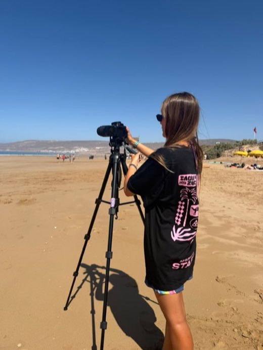 Staff filming surfers from the beach