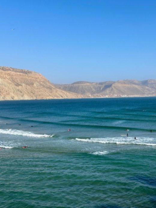 Surfers waiting for waves in the bay of Imsouane