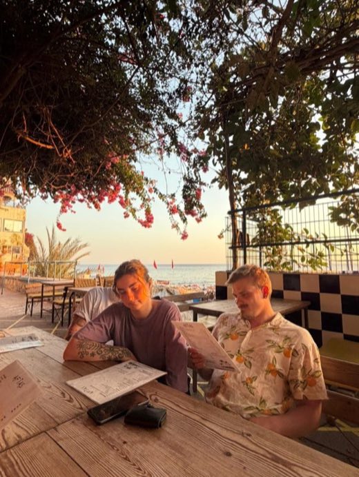 Guests reading the menu at a seaside restaurant