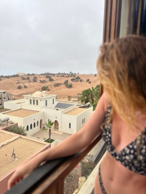 Guest on an apartment balcony looking over the hills