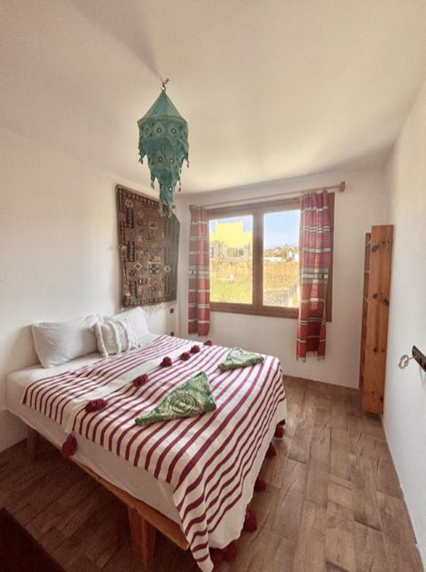 Bedroom with striped Moroccan bedspread