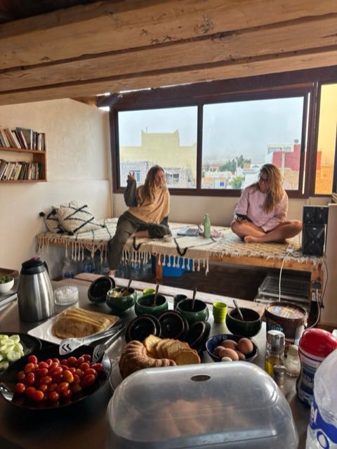Breakfast spread with guests relaxing by the window
